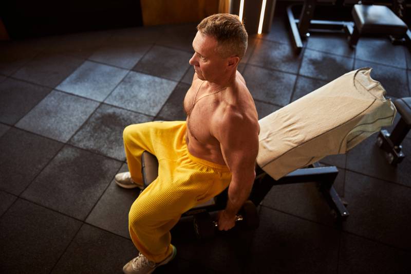 serious-man-yellow-sweatpants-sitting-on get strong ss