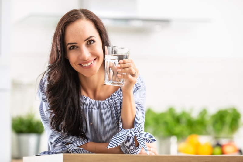 Woman Holds a Glass of Water | Menopause and Joint Pain