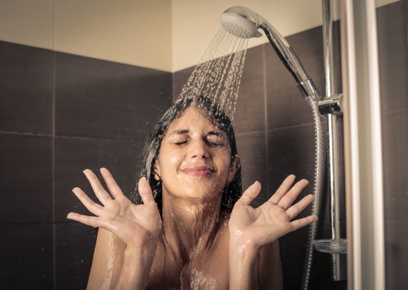 Girl under shower | Cold shower vs hot shower