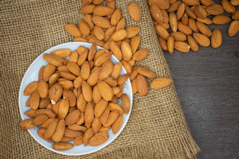 Brown Almond Nuts on White Plate | Mediterranean Diet