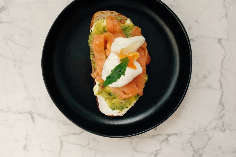 Plate with Tasty Toast with Fish and Poached Egg Served on Table | Mediterranean Diet