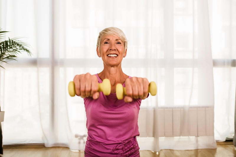 Portrait of Senior Woman Sitting on Exercise Mat with Dumbbells at Home | Standing Core Exercises for Seniors