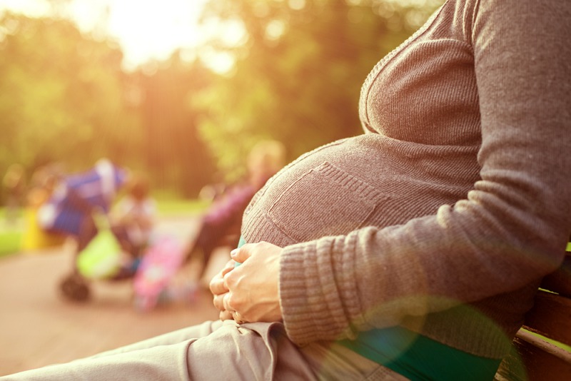 pregnant woman sitting on bench background | Laryngopharyngeal Reflux