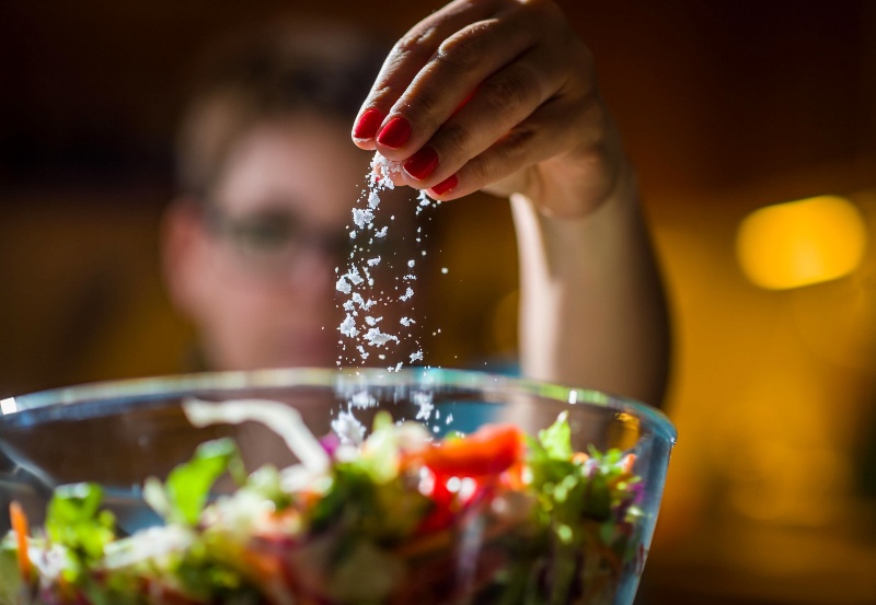 Woman Preparing Healthy Salad in Kitchen | What Does DASH Diet Mean