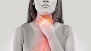 woman suffering acid reflux heartburnisolated on | Silent Acid Reflux Causes | Featured