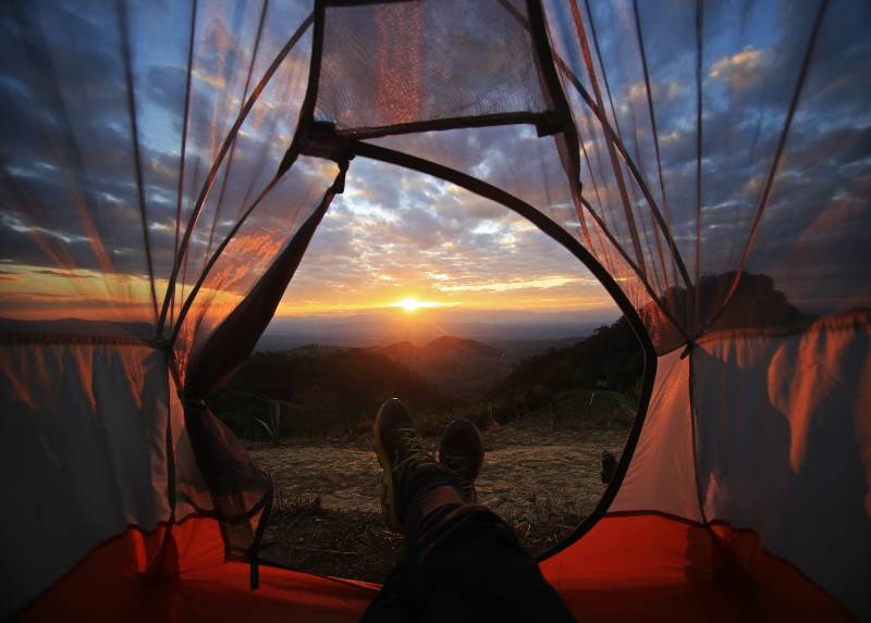 A camping tent glows under sunset to a night sky Outdoor Camping adventure-Why Camping Is Good For Your Health