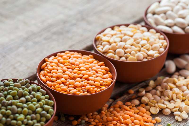 Bowls of cereal grains red lentils, green mung, corn, beans and peas-daniel diet food list