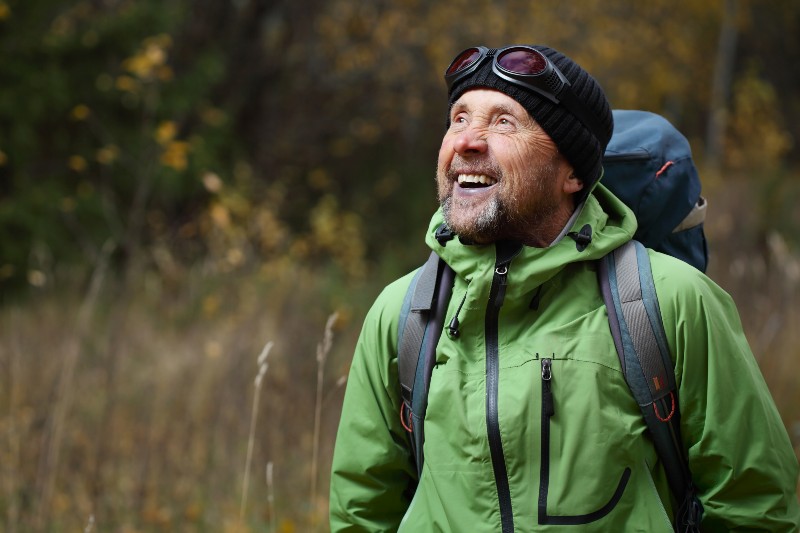 Happy mature backpacker in an autumn forest-Why Camping Is Good For Your Health