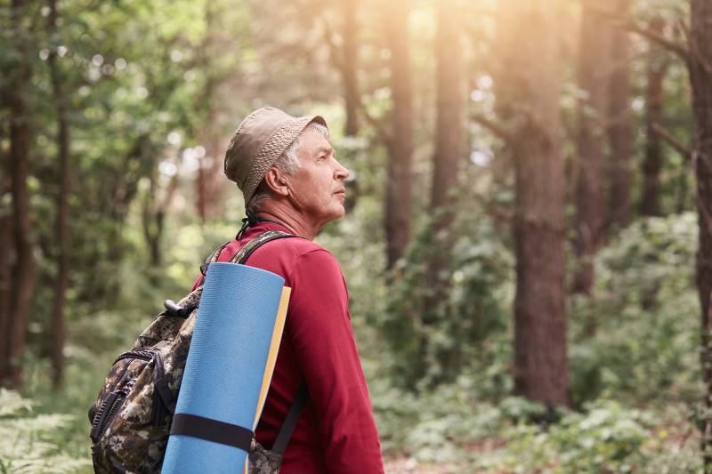 Profile of senior man looking aside attentively, going camping-Why Camping Is Good For Your Health