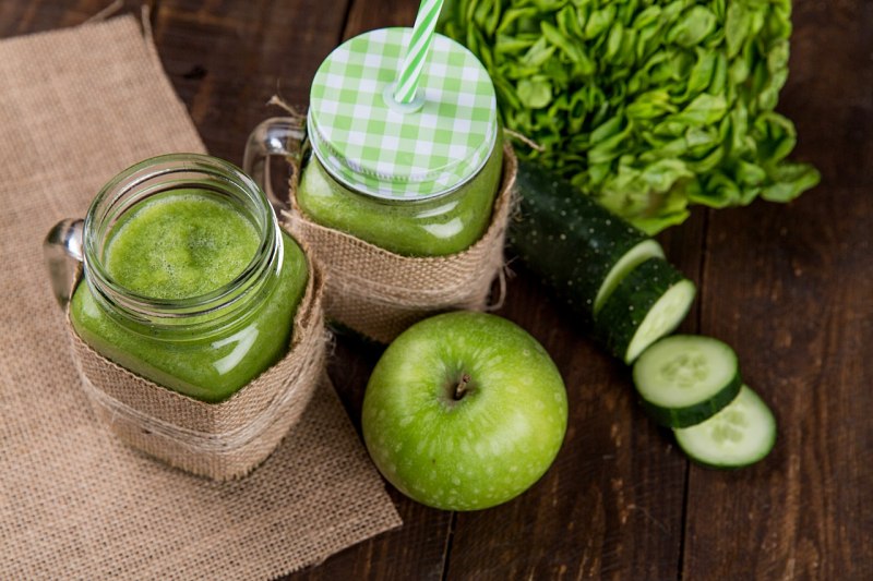 green apple beside of two clear glass jars | juicing vs eating