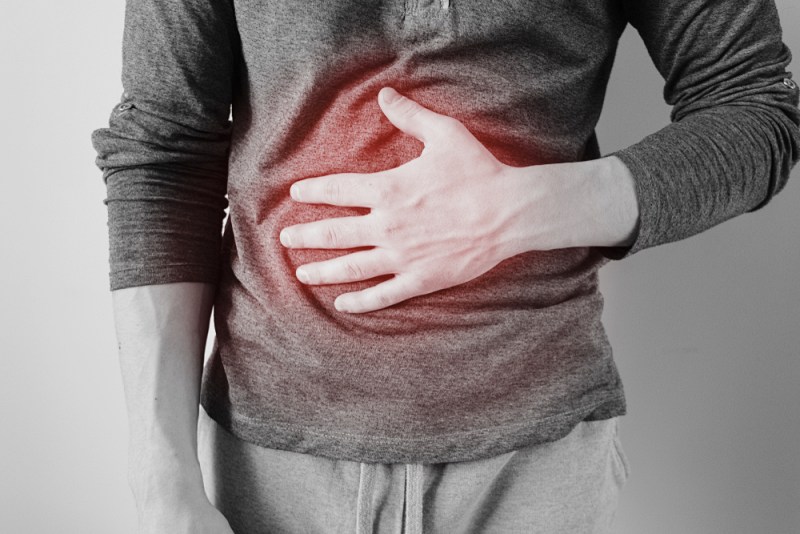 man holds stomach pain his chest | side pain