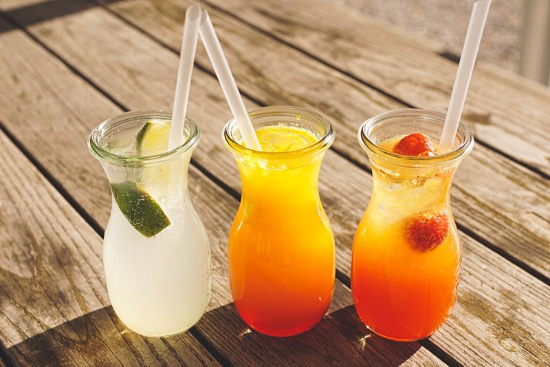 three assorted fruit juice in glasses | juicing vegetables vs eating 