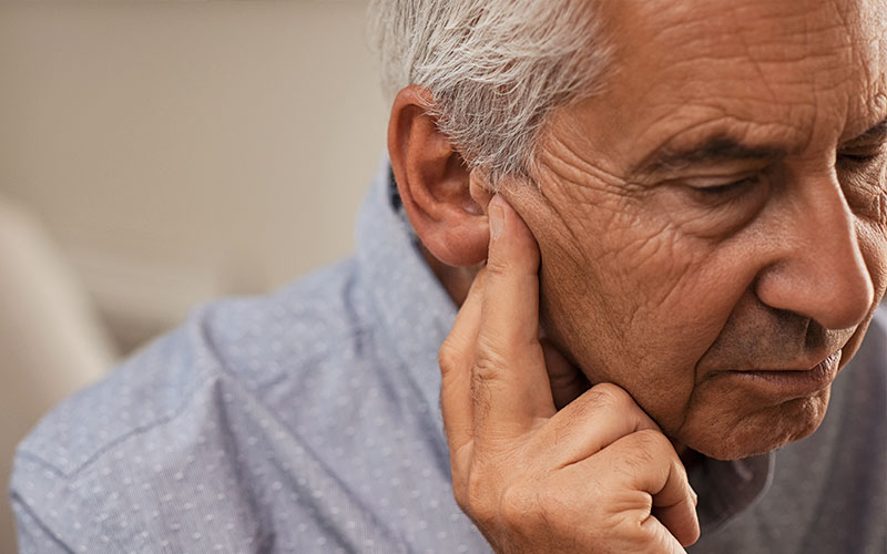 Side view of senior man with symptom of hearing loss | Does Tinnitus Go Away | 9 Signs That Tinnitus is Going Away