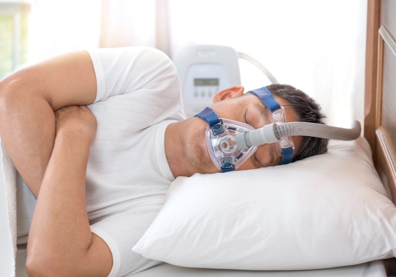 Happy and healthy senior man wearing Cpap mask sleeping smoothly all night long on his left side cross arms without snoring. sleep apnea therapy. How to treat prediabetes naturally