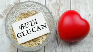 Rolled oat in a bowl with a piece of paper written Beta Glucan on it | Beta-Glucan and Its Notable Health Benefits | featured