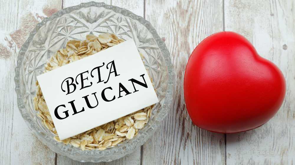 Rolled oat in a bowl with a piece of paper written Beta Glucan on it | Beta-Glucan and Its Notable Health Benefits | featured