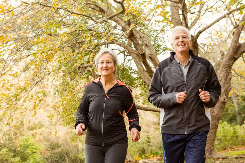 Senior couple in the park on an autumns day | Preventative Medicine