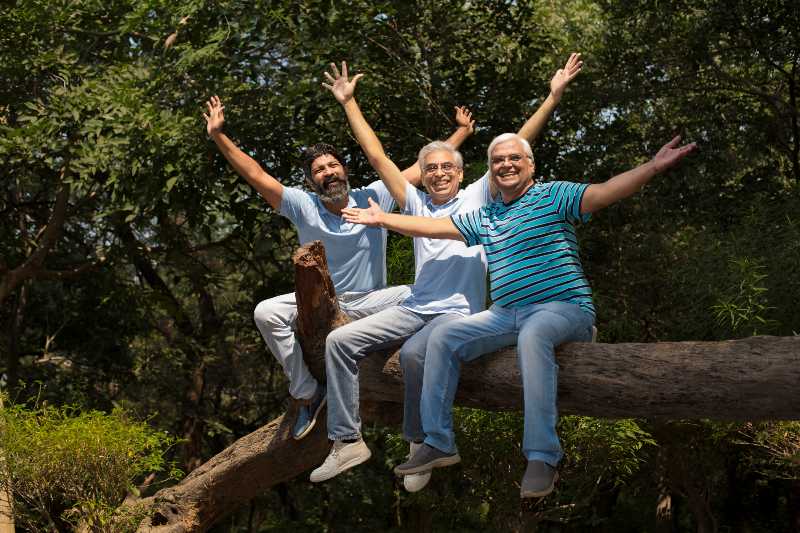 Three laughing senior friend relaxing at the park | Preventative Medicine