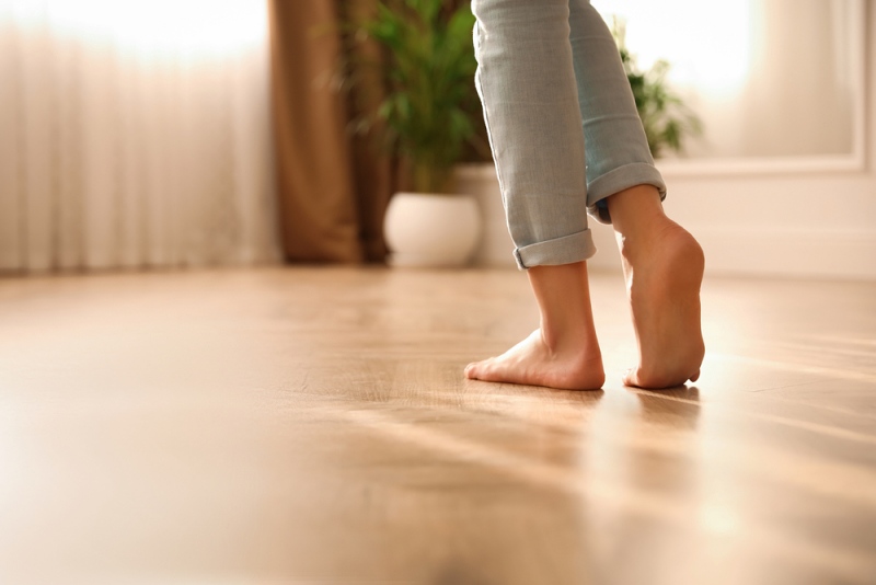 barefoot woman home closeup floor heating | how to burn fat while sleeping