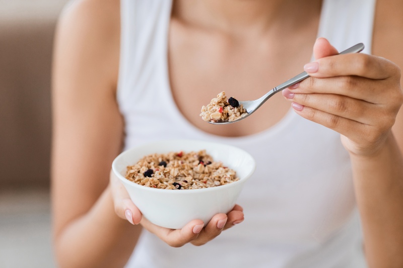 Cropped Image of Woman Holding Bowl with Homemade Granola or Oatmeal | How to Increase Insulin Sensitivity Naturally