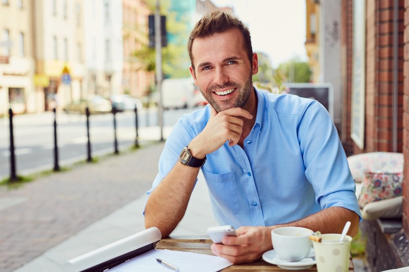 Happy Man Having Coffee Break Outdoors | How to Look Younger at 40