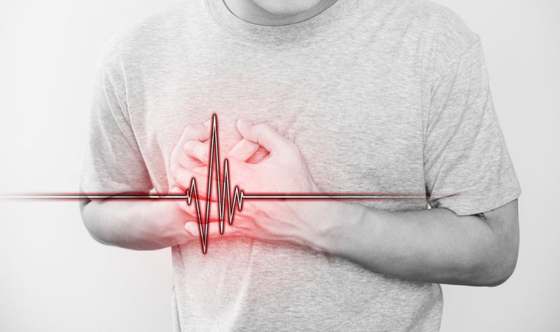 man touching his heart pulse sign | how to help angina