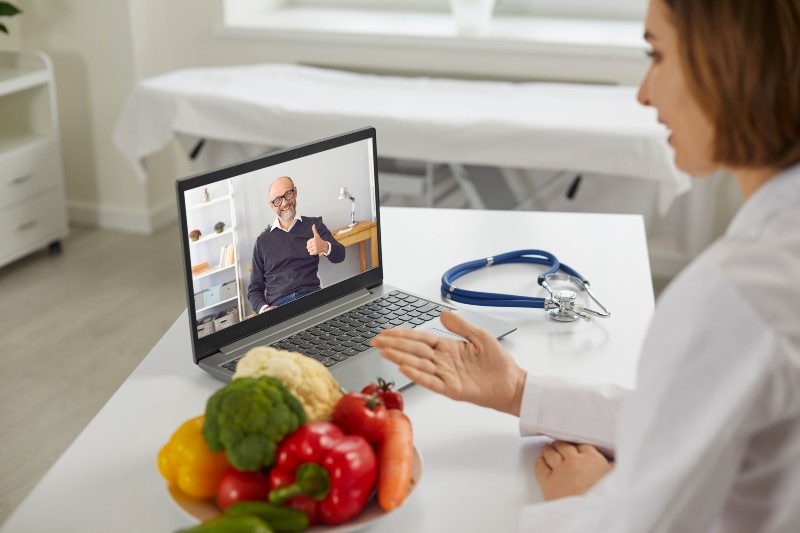 nutritionist sitting at laptop and talking to happy smiling satisfied elderly client | Consult a nutritionist | How to Reverse Prediabetes Naturally