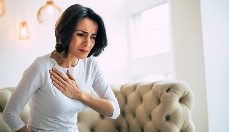pressure chest close photo stressed woman | angina vs heart attack
