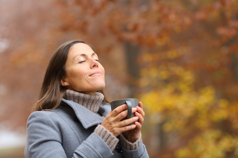 Relaxed Middle-Aged Woman Holding Coffee Cup | How to Look 10 Years Younger