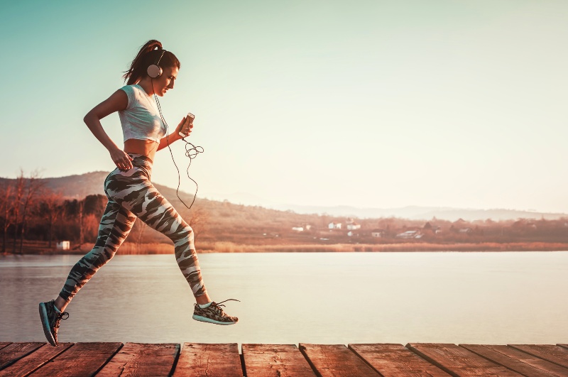 Running Fit Woman with Headphones Outdoors | How to Increase Insulin Sensitivity Naturally