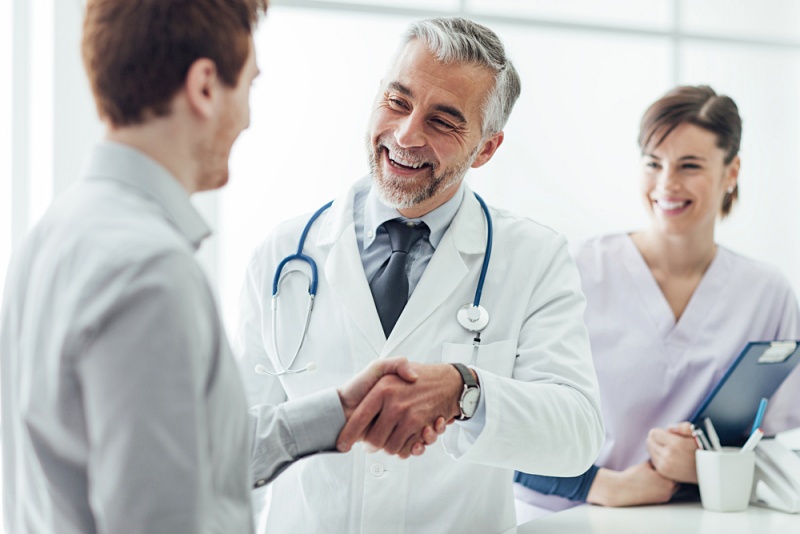 smiling doctor clinic giving handshake his | left side pain under ribs