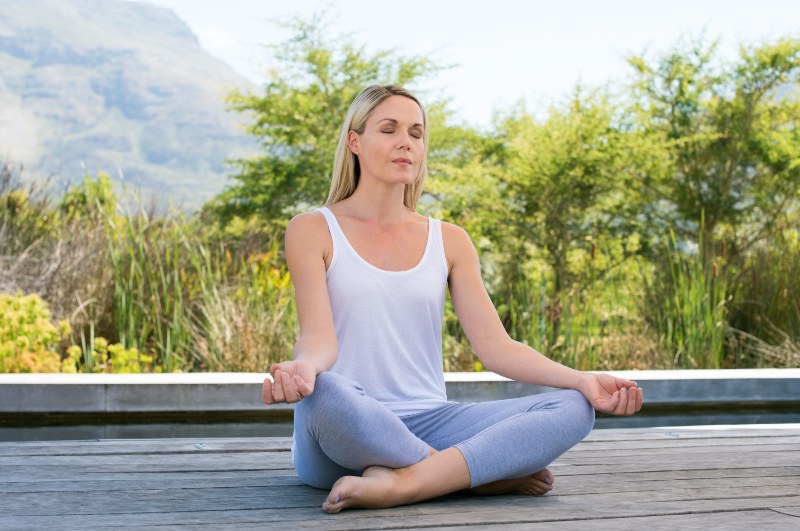 Woman Practicing Yoga and Meditating Outdoors | Keto for Women over 50