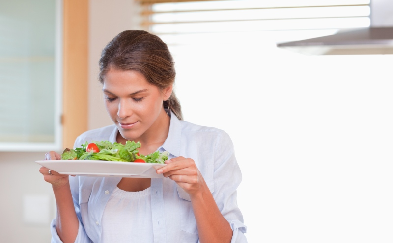 Woman Smelling a Salad in Her Kitchen | Keto for Women over 50