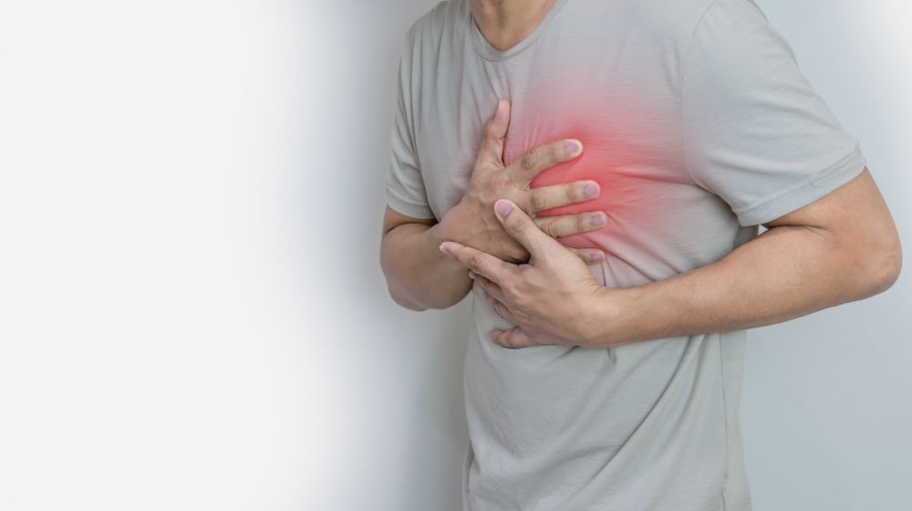 Hands holding chest symptoms heart attack | Organic heart disease