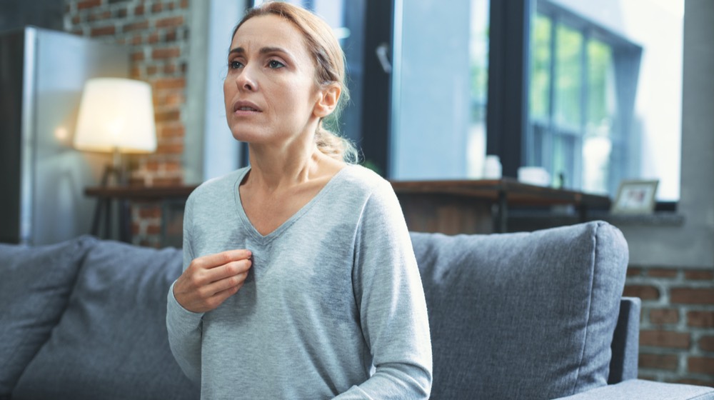 what causes hot flashes Causes of Hot Flashes Other Than Menopause Hot flashes. Exhausted mature woman resting on sofa and having hot flash | what can cause hot flashes other than menopause