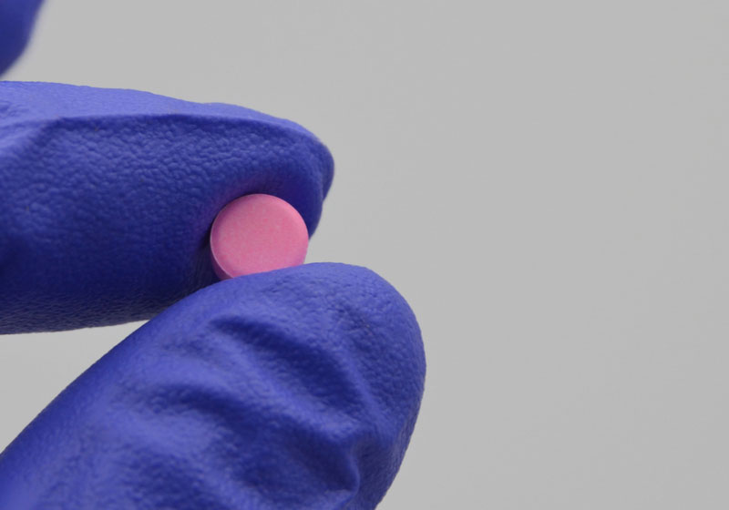 Pink tablet of warfarin (blood thinner) on hand | Is Tylenol a Blood Thinner?