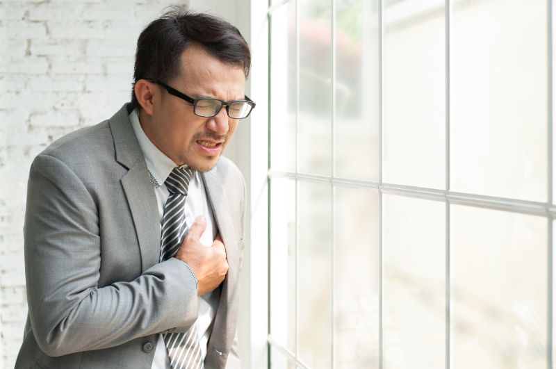 Stress asian businessman standing near window | COPD and heart failure