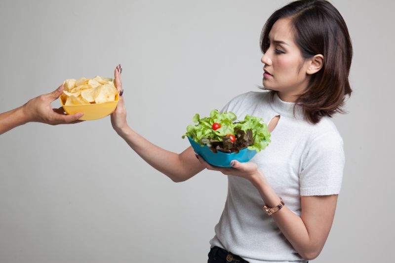 Young asian woman salad say no | What to avoid after stent