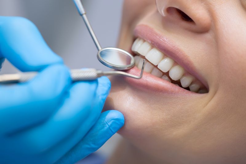 dentist examining patients teeth dental health and care