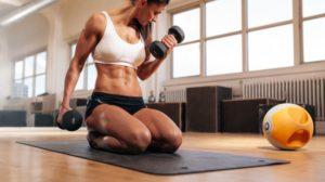 physically fit woman gym lifting dumbbells Building Muscle | Featured Image