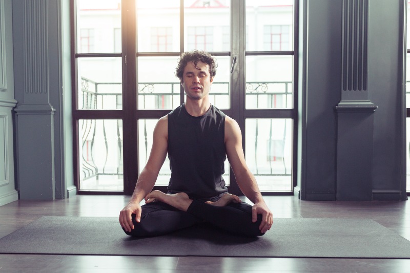 Young Man Meditates while Practicing Yoga | How to Build Your Immune System to Fight HPV