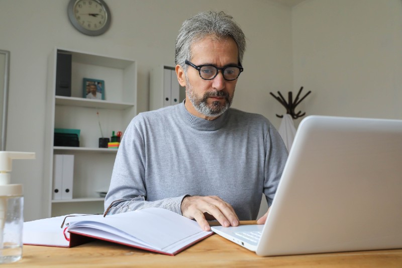 Mature Man Talking With a Doctor Online Using Laptop | Strategy