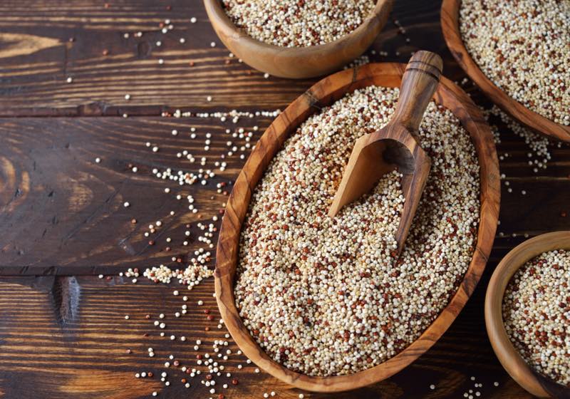 quinoa benefits | Quinoa in bowl on brown background | what is quinoa 