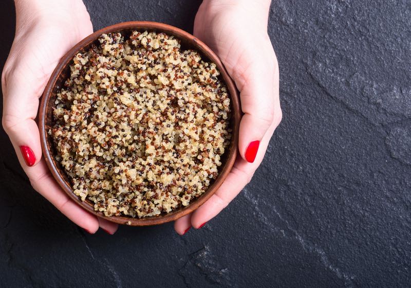 Healthy cooked quinoa in woman hand . Superfood Quinoa Benefits | Quinoa is a complete protein