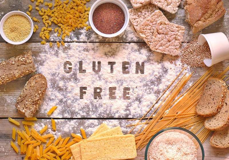 Quinoa Benefits | Quinoa is Gluten Free _ Gluten free flour and cereals millet, quinoa, corn bread, brown buckwheat, rice, bread and pasta with text gluten free in English language