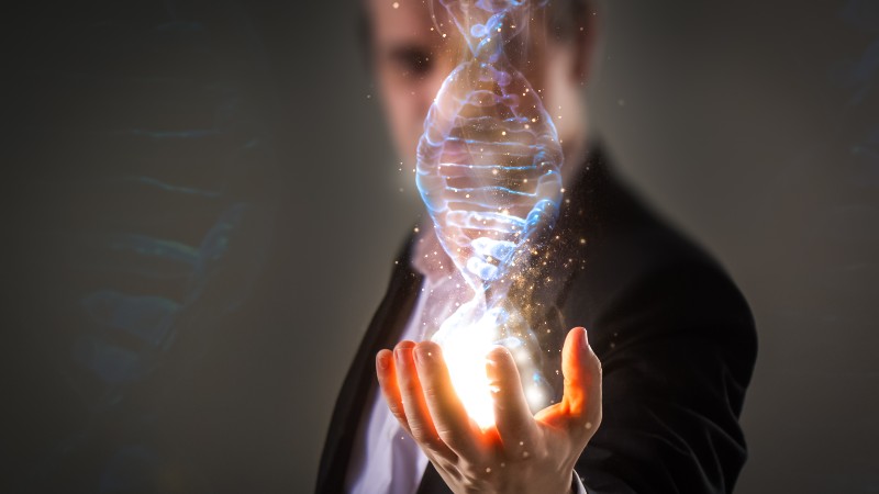 close up of Businessman holding glowing DNA helix with energy sparks | How Our Genes Impact Viruses & Why Disease Symptoms Are Not The Problem - With Dr. Ben Lynch