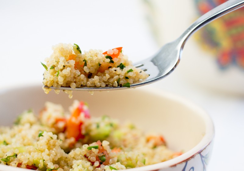 quinoa salad close up in a white bowl | Quinoa Benefits: The Health Benefits of This Gluten-Free Grain
